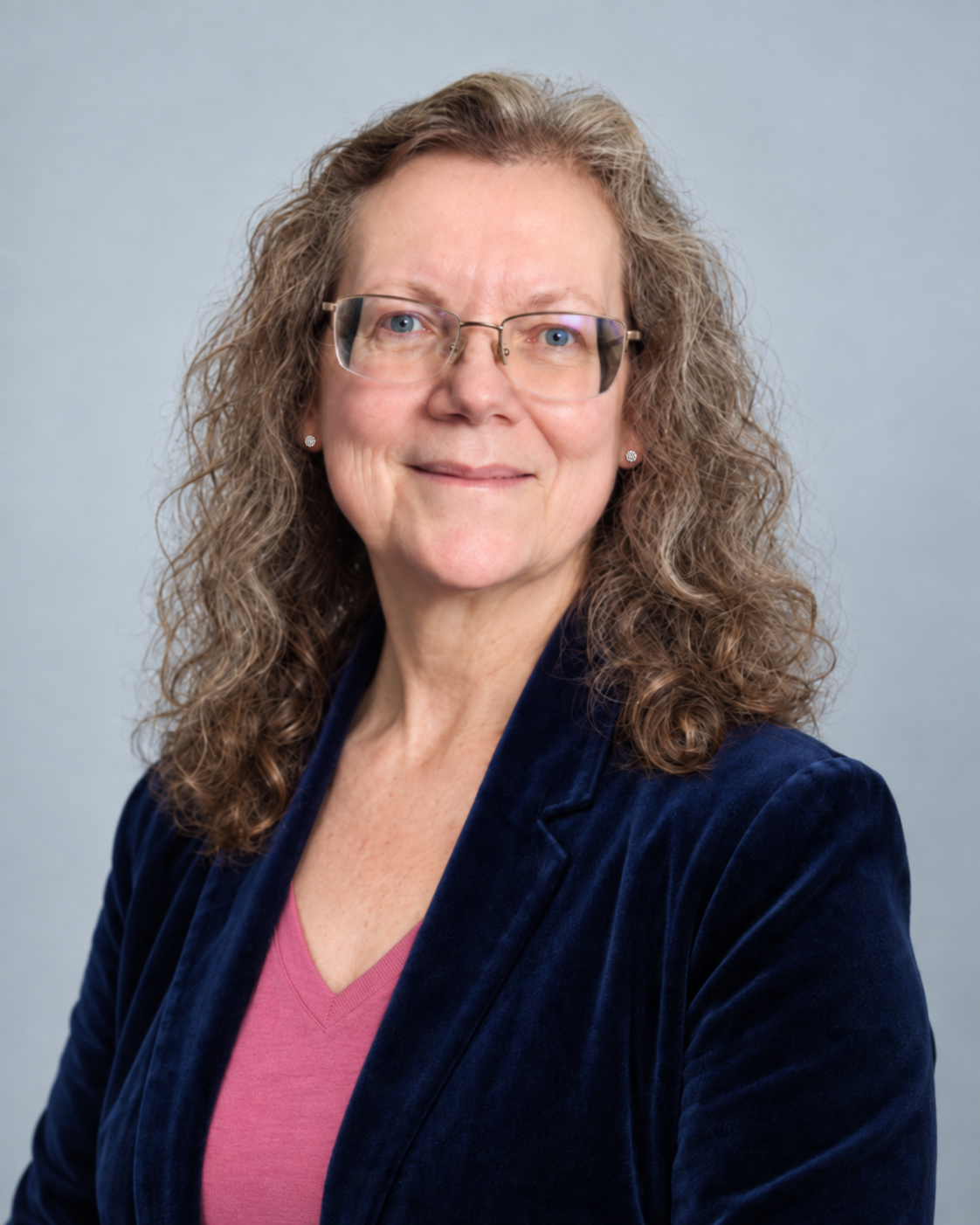 Patti L. Curtin wearing a navy jacket and pink top